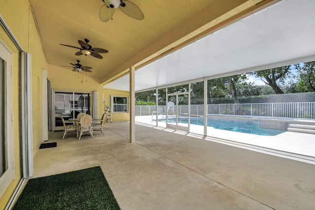 view of swimming pool featuring ceiling fan and a patio area