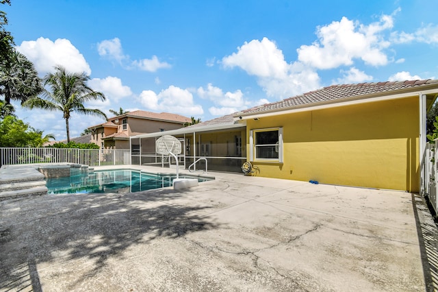 view of pool featuring a sunroom and a patio