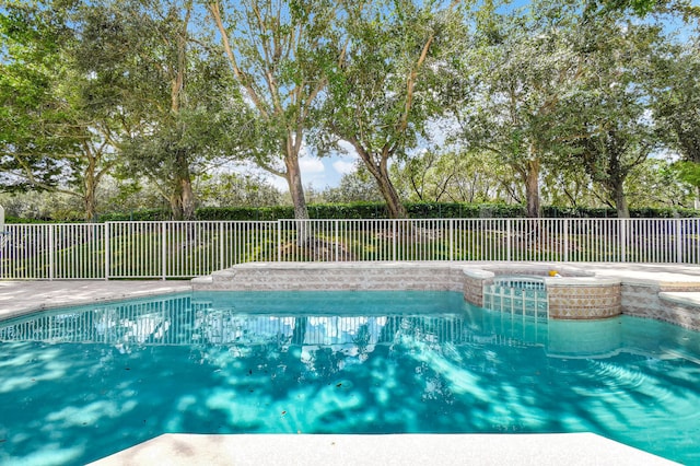 view of swimming pool with an in ground hot tub