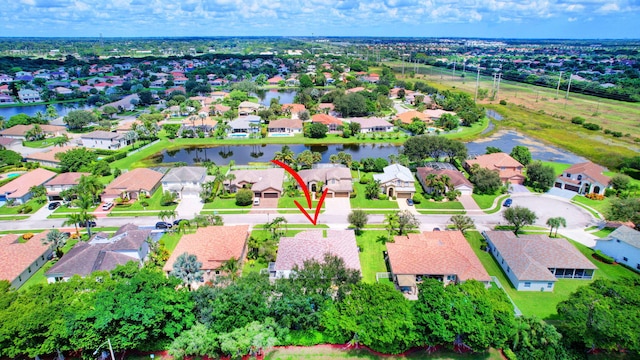 birds eye view of property with a water view