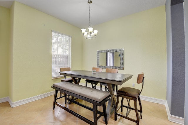 tiled dining area with an inviting chandelier