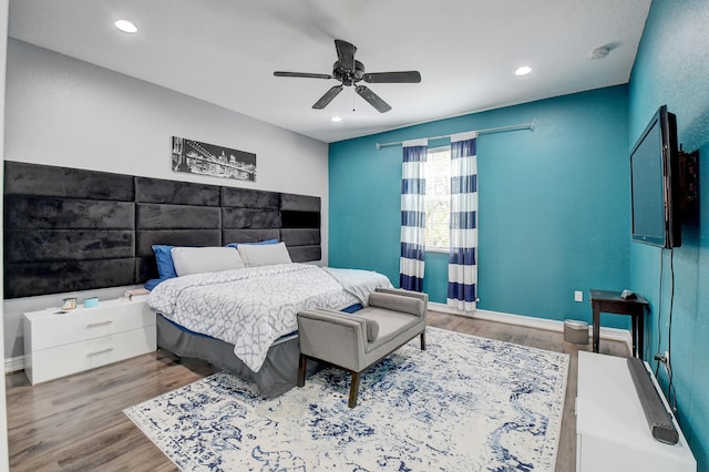 bedroom with ceiling fan and wood-type flooring