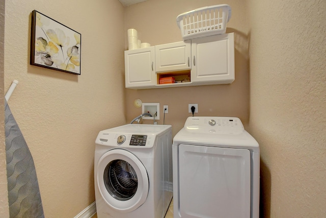 laundry room featuring cabinets and washing machine and clothes dryer