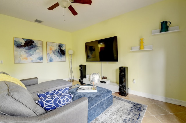 living room with ceiling fan and tile patterned floors