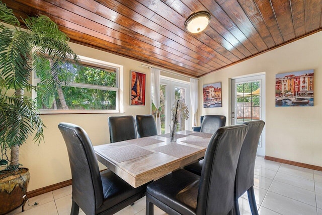 dining area with baseboards, wood ceiling, vaulted ceiling, light tile patterned floors, and french doors