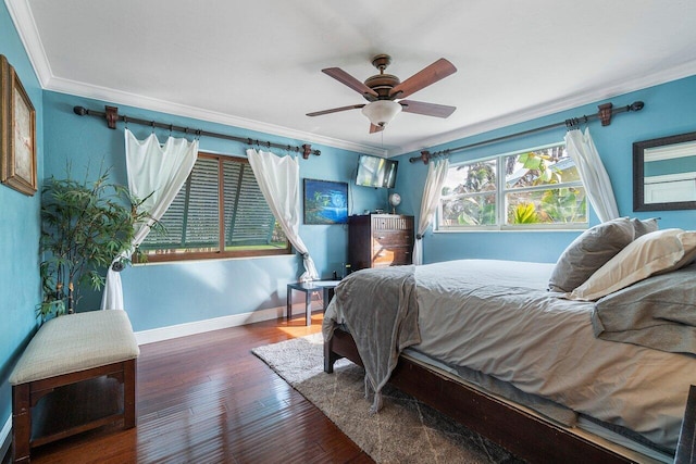 bedroom with ornamental molding, dark hardwood / wood-style flooring, and ceiling fan