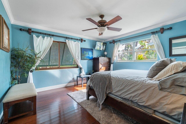 bedroom featuring ceiling fan, baseboards, wood finished floors, and ornamental molding