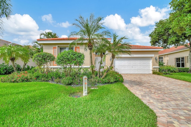 view of front of property with a garage and a front lawn