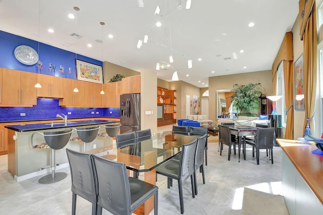 tiled dining space featuring sink