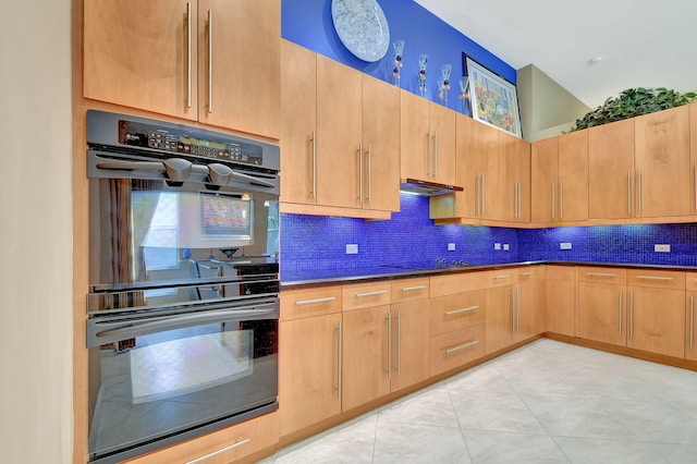 kitchen with black appliances, backsplash, light brown cabinetry, and light tile patterned floors