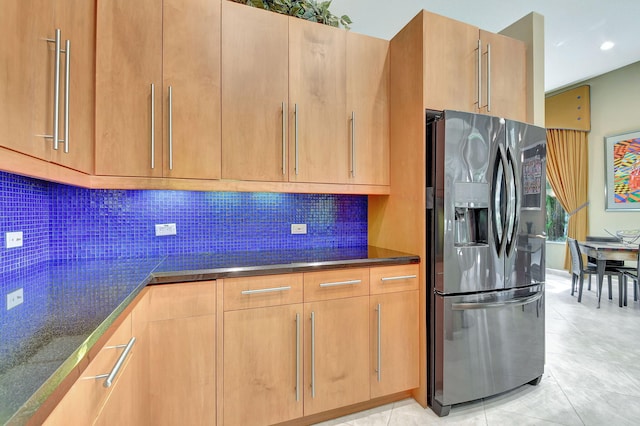 kitchen featuring light tile patterned floors, stainless steel fridge with ice dispenser, and decorative backsplash