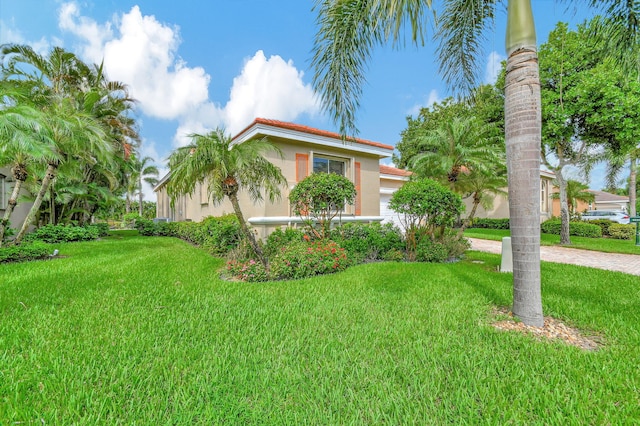 mediterranean / spanish-style home featuring a front yard