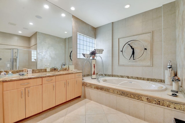 bathroom featuring plus walk in shower, tile walls, tile patterned floors, and vanity