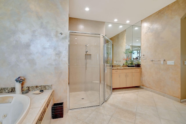 bathroom featuring tile patterned floors, independent shower and bath, and vanity