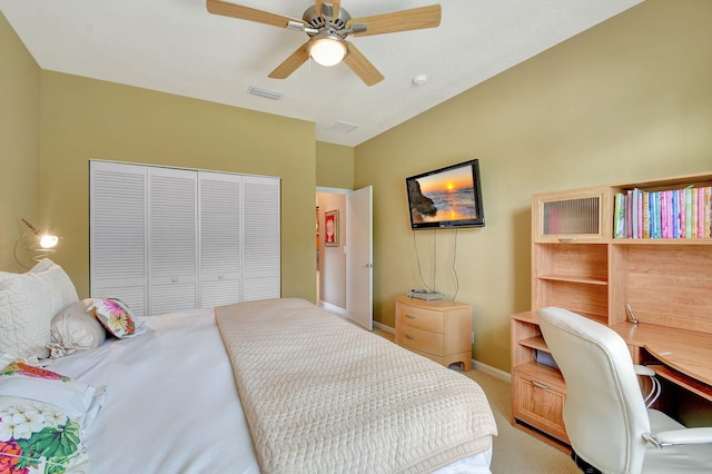 carpeted bedroom with ceiling fan and a closet