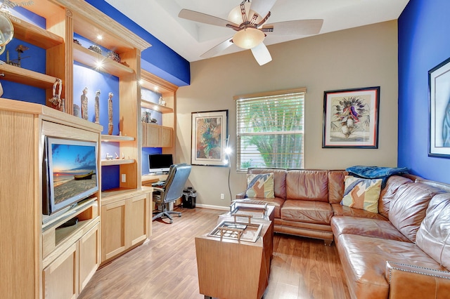 living room with light hardwood / wood-style floors and ceiling fan