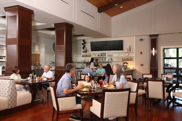 dining room with wood ceiling, high vaulted ceiling, beamed ceiling, and dark hardwood / wood-style floors