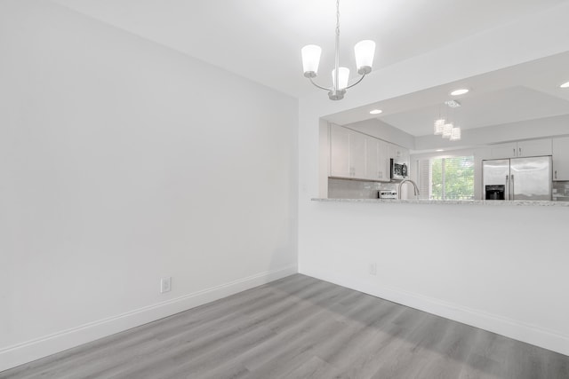 interior space featuring light hardwood / wood-style floors and a chandelier