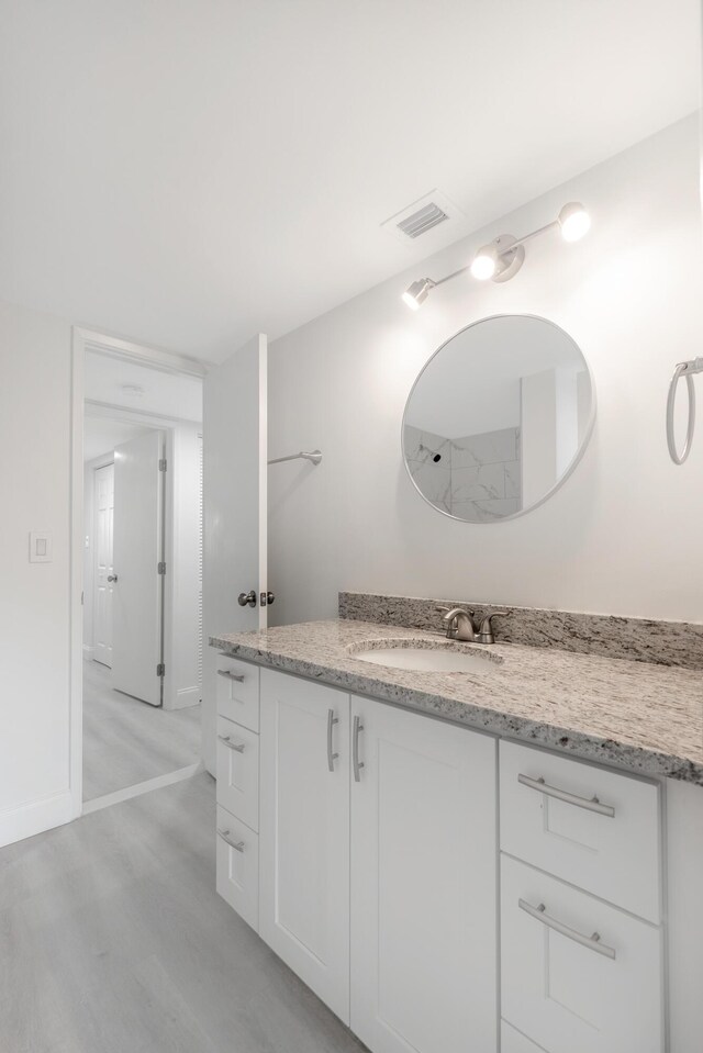 bathroom featuring vanity and hardwood / wood-style flooring