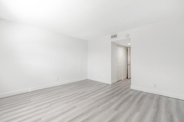 spare room featuring light hardwood / wood-style flooring