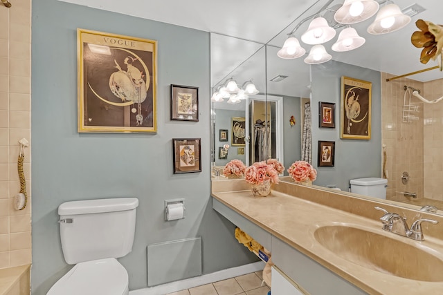 full bathroom with toilet, vanity, tiled shower / bath, and tile patterned floors