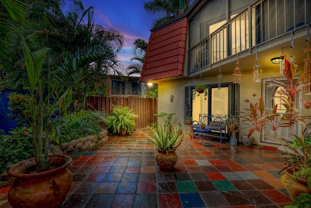 patio terrace at dusk with a balcony