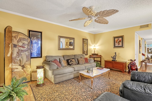 living room with a textured ceiling, hardwood / wood-style flooring, and crown molding