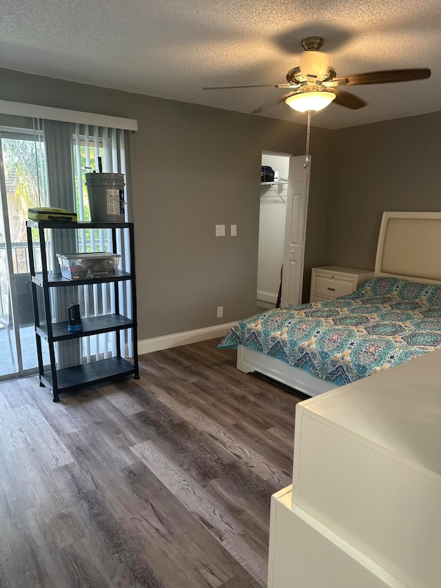 bedroom featuring a textured ceiling, access to exterior, ceiling fan, and dark hardwood / wood-style floors