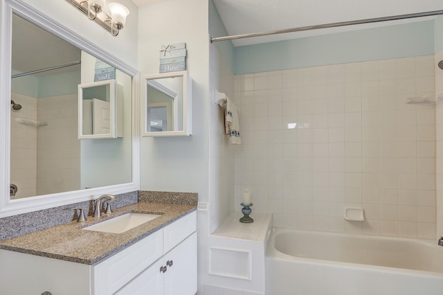 bathroom featuring tiled shower / bath combo and vanity