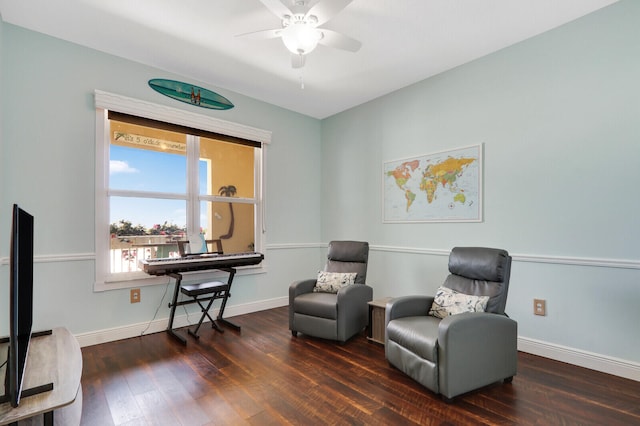 sitting room with ceiling fan and dark hardwood / wood-style floors