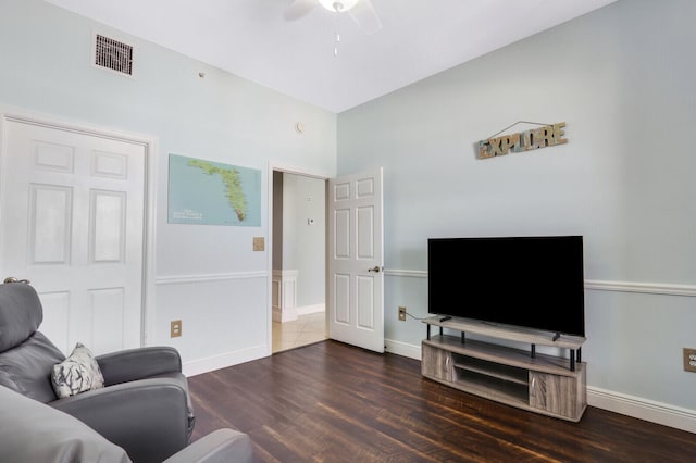 living room with ceiling fan and dark hardwood / wood-style flooring