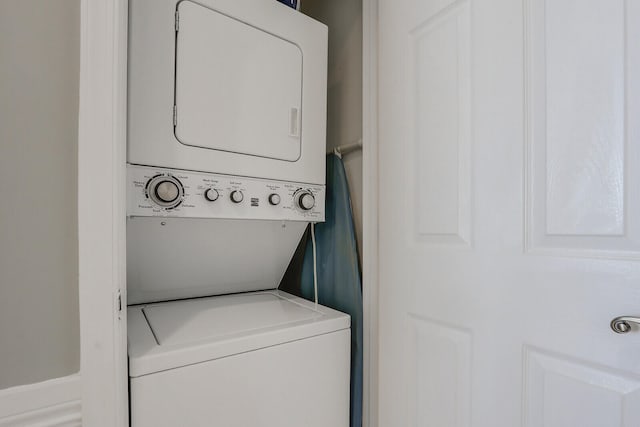 laundry area with stacked washer / dryer