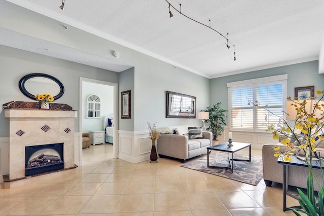 living room featuring ornamental molding, a textured ceiling, track lighting, and light tile patterned flooring