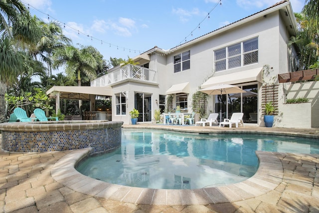 back of house featuring a patio and a balcony