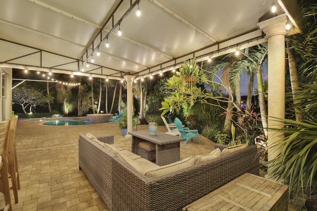 pool at dusk featuring a patio area