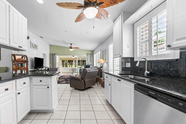 kitchen featuring ceiling fan, white cabinets, plenty of natural light, and stainless steel dishwasher