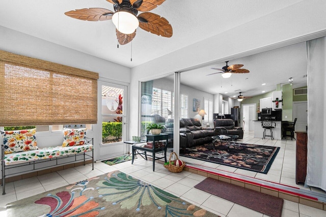 tiled living room with ceiling fan