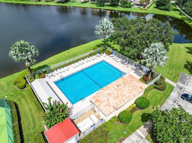 view of pool featuring a water view, a yard, and a patio area