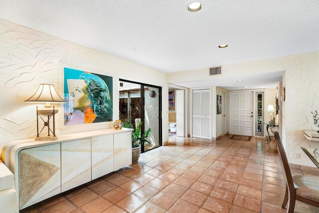 tiled foyer featuring a textured ceiling