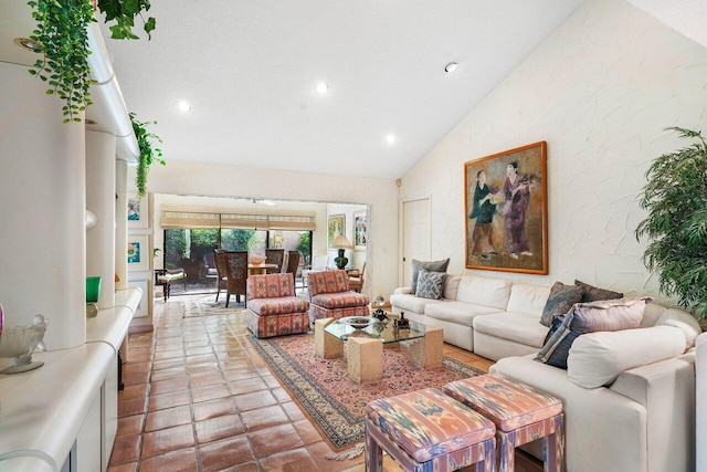 living room with a textured ceiling and high vaulted ceiling