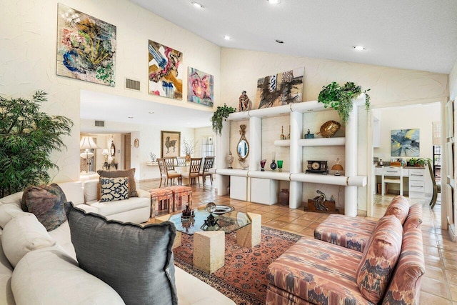 living room with light tile patterned flooring, a textured ceiling, and vaulted ceiling