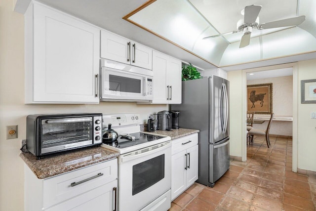 kitchen with ceiling fan, white cabinets, dark stone counters, and white appliances