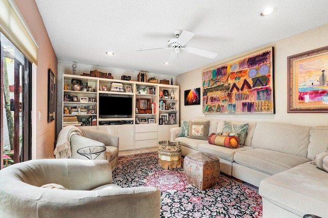 living room with a textured ceiling and ceiling fan