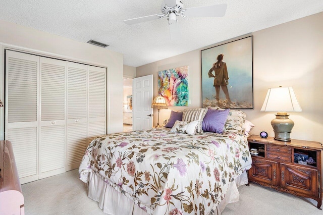 bedroom with ceiling fan, a closet, and light colored carpet