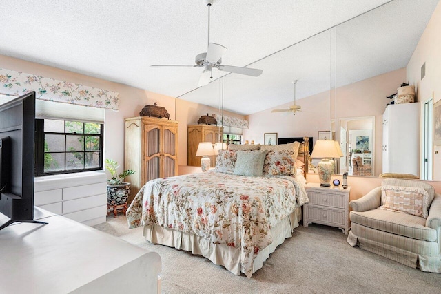 bedroom with light carpet, a textured ceiling, ceiling fan, and lofted ceiling