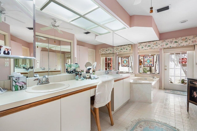 bathroom featuring vanity, a tub to relax in, tile patterned floors, and ceiling fan