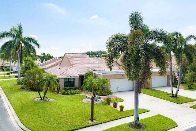 view of front of property featuring a front yard and a garage