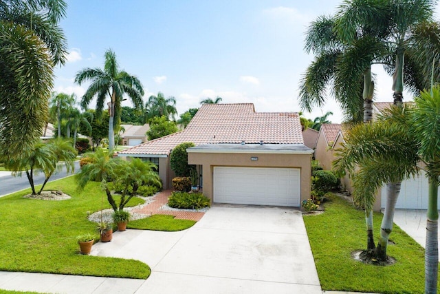 mediterranean / spanish-style home with a front yard and a garage