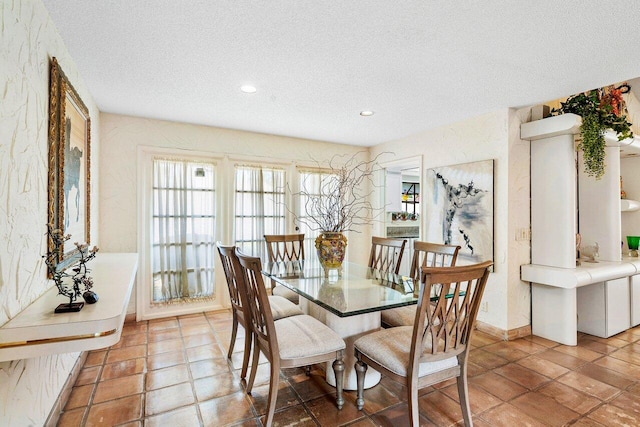 dining space with a textured ceiling