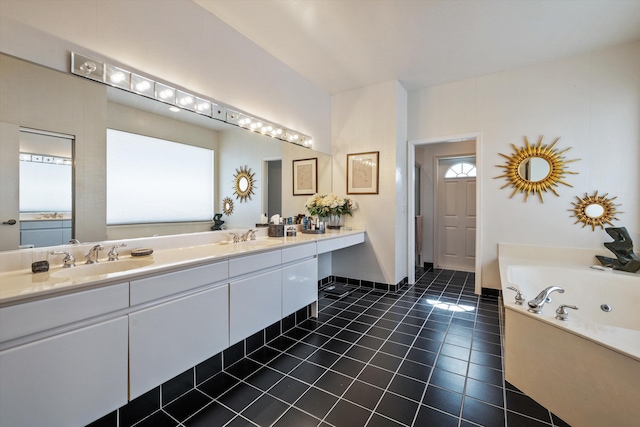 bathroom featuring a tub, vanity, tile patterned flooring, and a healthy amount of sunlight